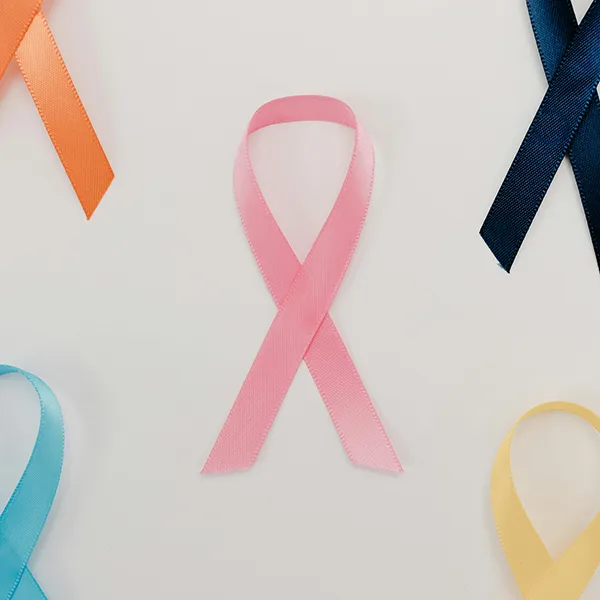 pink folded ribbon with other coloured ribbons around it.